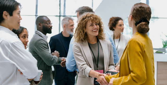 People in business setting chatting