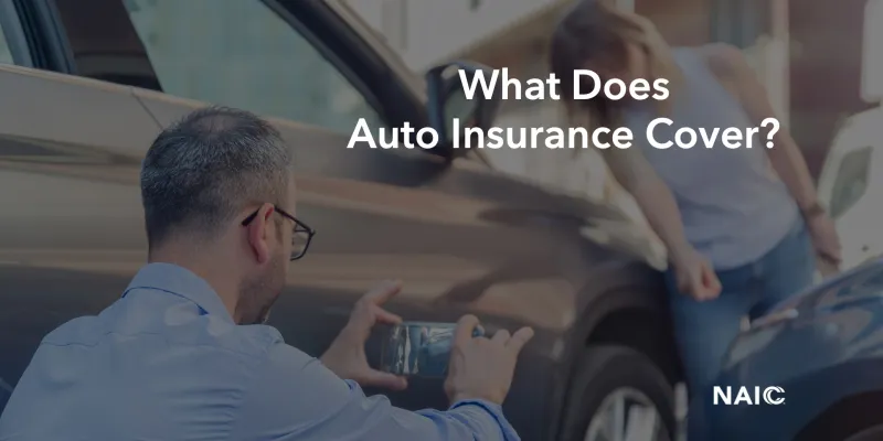 A man is taking a picture of the aftermath of a car crash with a cell phone. There is a woman in the background looking at the damage. The image says, "what does auto insurance cover?"