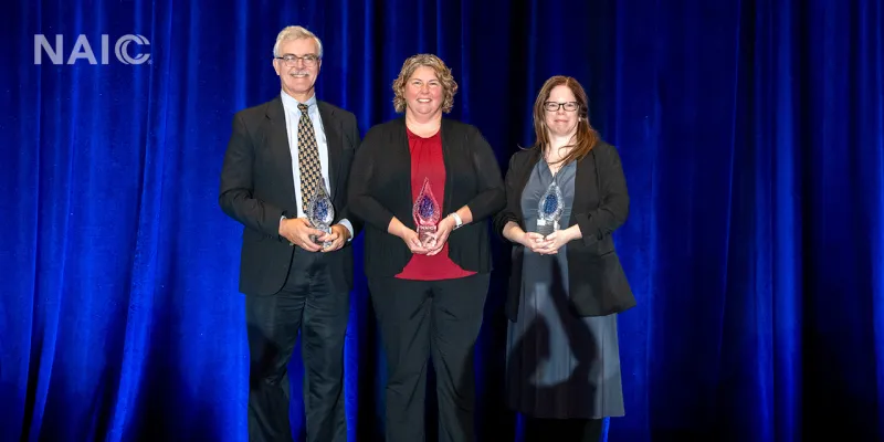 Kevin Beagan, Amy Malm, and Jamie Walker pose with their 2025 Robert Dineen Award, recognizing Outstanding Service and Contribution to the State Regulation of Insurance.
