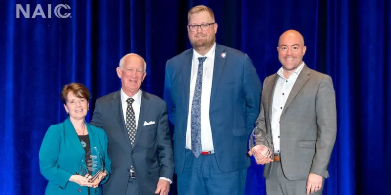 Ohio Department of Insurance Director Judith L. French and Wisconsin Insurance Commissioner Nathan Houdek, the 2025 recipients of the NAIC's Raymond G. Farmer Award for Exceptional Leadership, pose with Former South Carolina Department of Insurance Director Farmer and North Dakota Insurance Commissioner and NAIC President Jon Godfread.