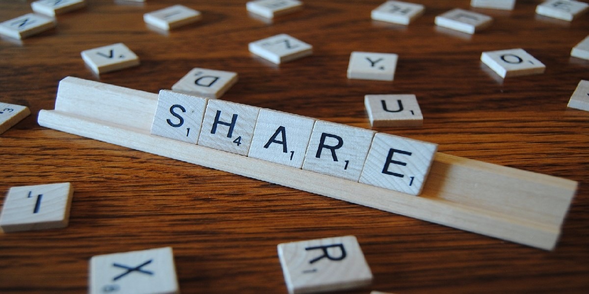Scrabble tiles spelling the word "Share"