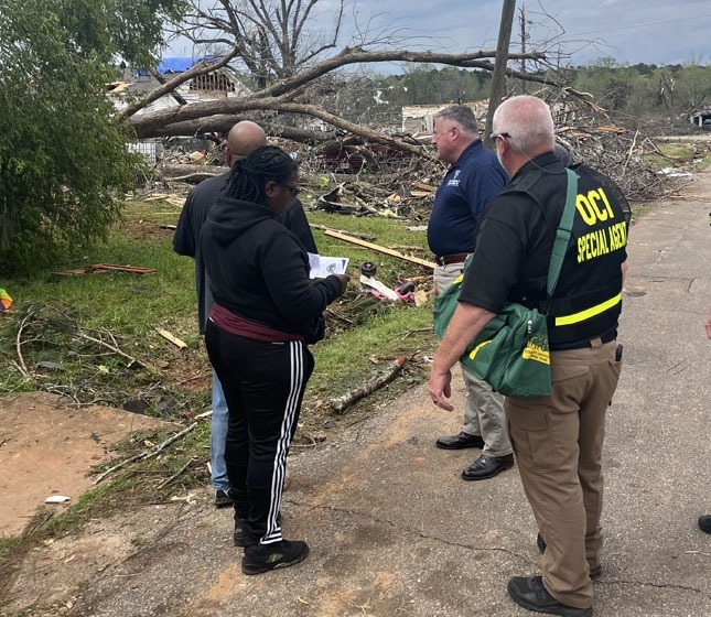 Group of people looking at damage from storm