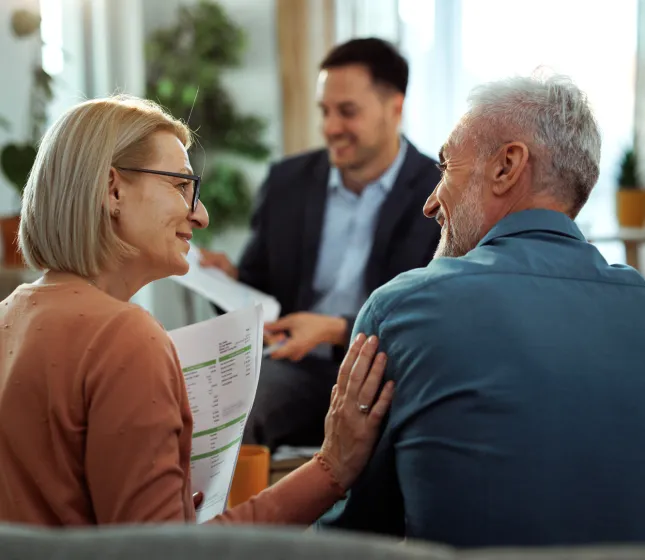 Older couple discussing something with advisor or sales