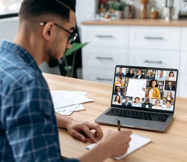 Student Taking Notes Watching Webinar